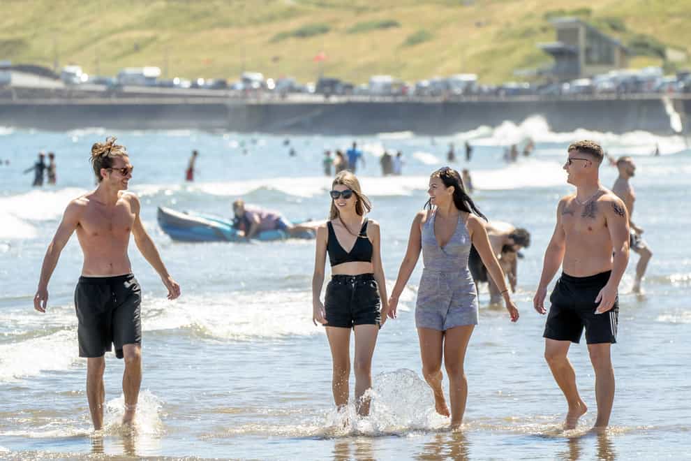 People enjoying the warm weather on Scarborough beach, North Yorkshire. Campaigners have warned of the risk of more sewage pollution on coastlines ahead of the bank holiday (Danny Lawson/PA)
