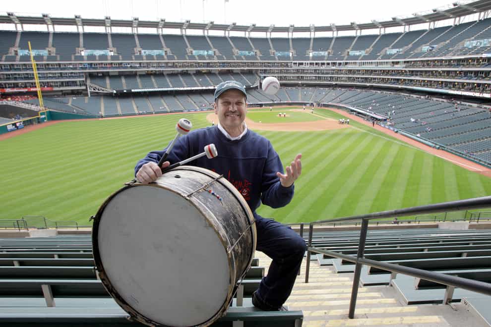 Cleveland fan John Adams poses in his usual centrefield bleacher seat with his ever-present bass drum before a baseball game in April 2011 in Cleveland (Amy Sancetta/AP)