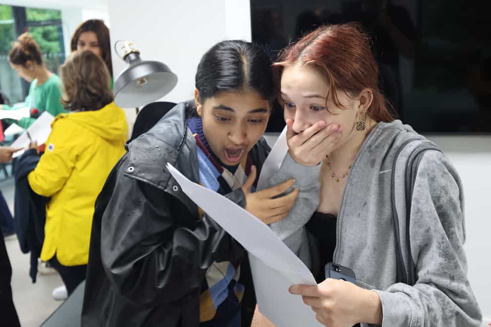 Milan (left) and Sasha (right) celebrate after receiving their GCSE results at Notting Hill and Ealing High School in Ealing, London (James Manning/PA)