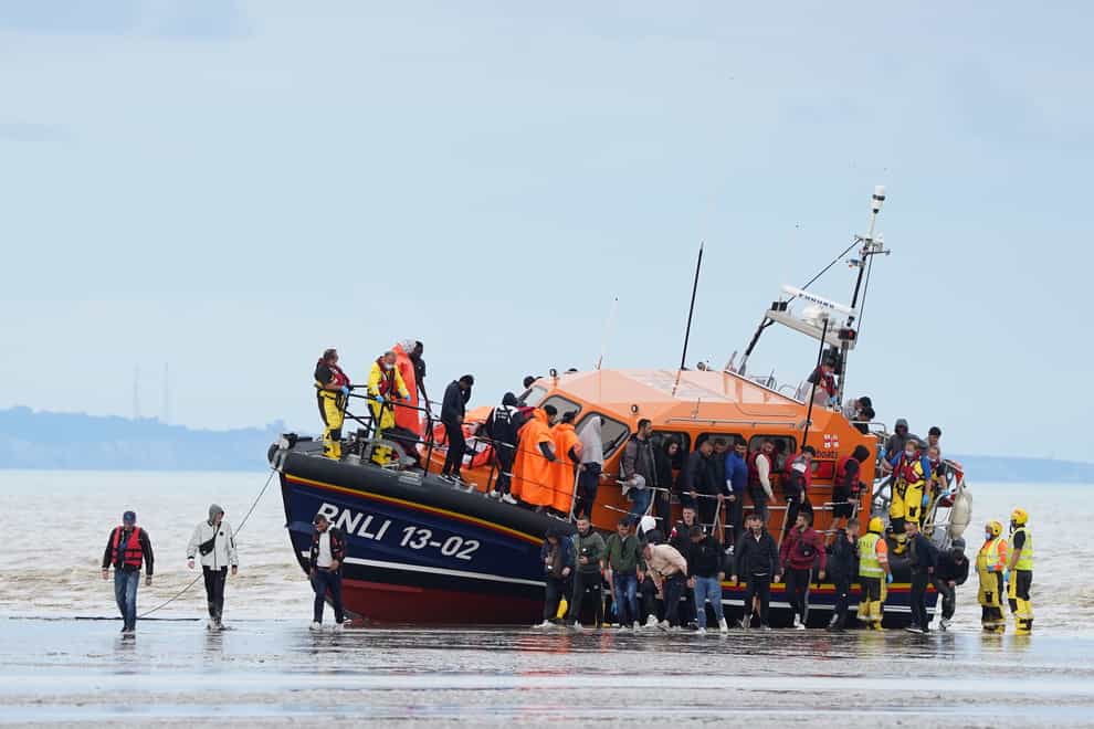A group of people thought to be migrants are brought in to Dungeness, Kent, by the RNLI, following a small boat incident in the Channel. Picture date: Thursday August 25, 2022. (Gareth Fuller/PA)