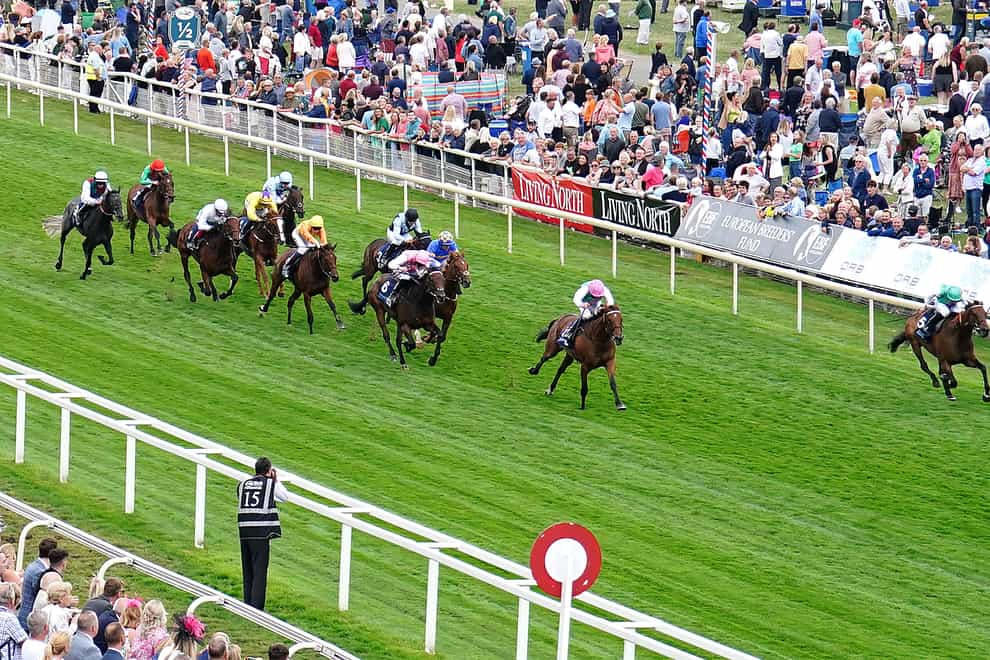 Haskoy ridden by jockey Ryan Moore (right) wins the British EBF & Sir Henry Cecil Galtress Stakes with Tim Lock ridden by jockey William Buick (second right) second during day two of the Ebor Festival at York Racecourse. Picture date: Thursday August 18, 2022.