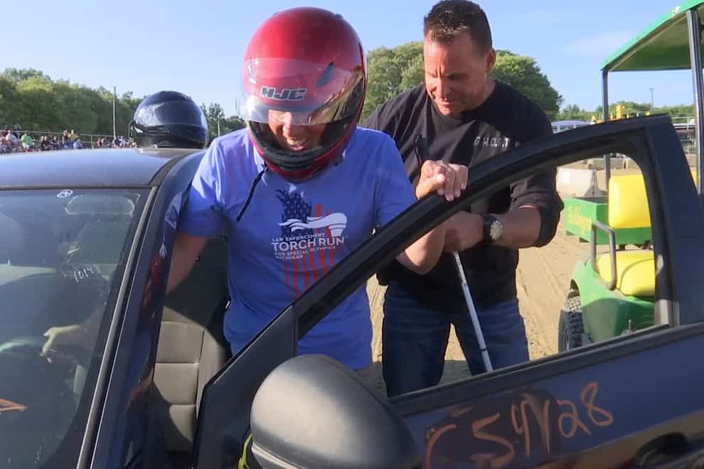 Michigan Supreme Court Justice Richard Bernstein, who is blind, gets into a car to drive for the first time at the Genesee County fairgrounds in Mt Morris, Michigan (WNEM-TV via AP)