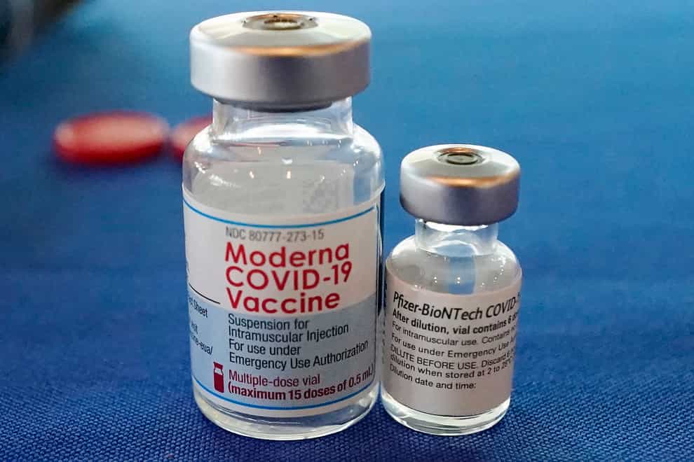 Vials of the Pfizer and Moderna Covid-19 vaccines (Rogelio V Solis/AP)
