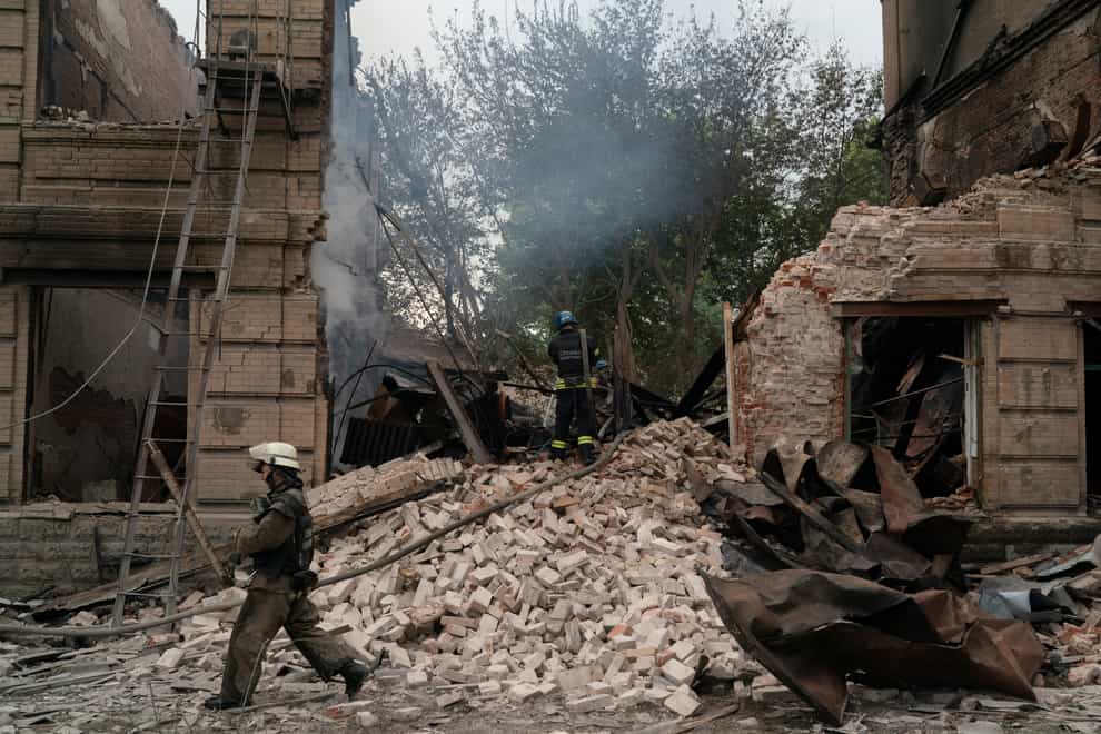 Firefighters work to extinguish a fire after a Russian attack damaged a building of a technical school in Slovyansk, Ukraine (Leo Correa/AP)