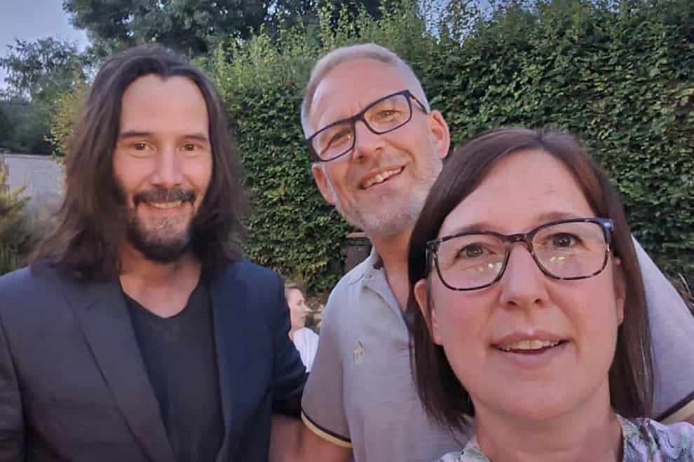 Keanu Reeves poses for a selfie with Dianne King and her husband Jason (Dianne King/PA)