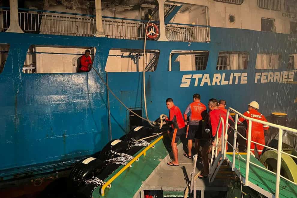 Coast guard personnel help in controlling the fire on M/V Asia Philippines (Philippine Coast Guard via AP)
