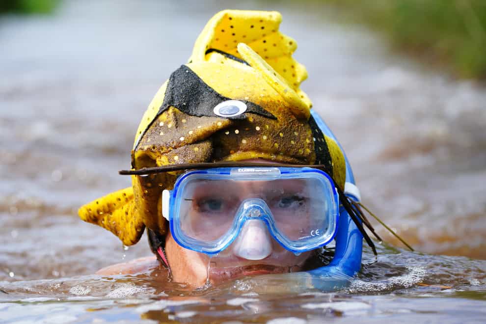 ompetitors in the bog section of the Rude Health Bog Triathlon at Llanwrtyd Wells, in Wales (Ben Birchall/PA)