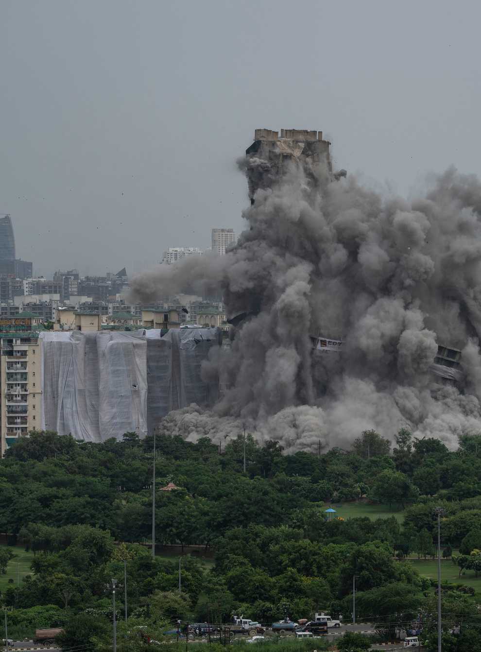 Cloud of dust rise as two high-rise apartment blocks are razed to the ground in Noida, on the outskirts of New Delhi, India (Altaf Qadri/AP)