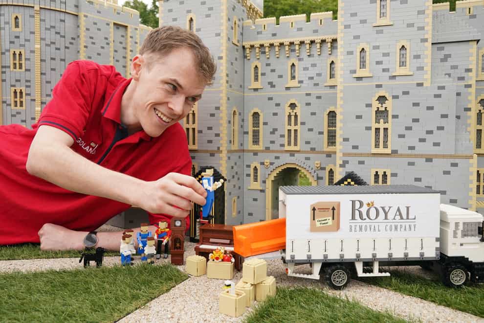 Legoland Windsor Resort Model Maker Will Metcalfe finalises the display of Lego figures of the Duke and Duchess of Cambridge as they are unveiled at Legoland Windsor to celebrate the royal couple moving to the local area with their family (Jonathan Brady/PA)