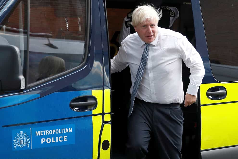 Prime Minister Boris Johnson leaves a police vehicle after watching a drugs-related raid by Metropolitan Police officers (Peter Nicholls/PA)
