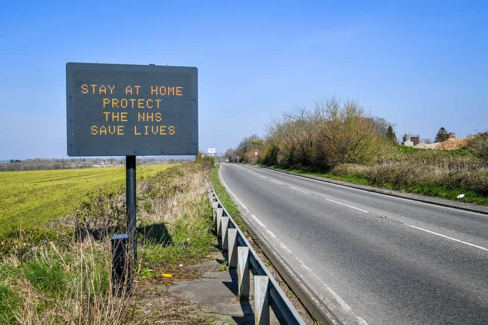 A road sign advises motorists to stay at home to protect the NHS and save lives the day after Prime Minister Boris Johnson put the UK in lockdown in 2020 (PA)