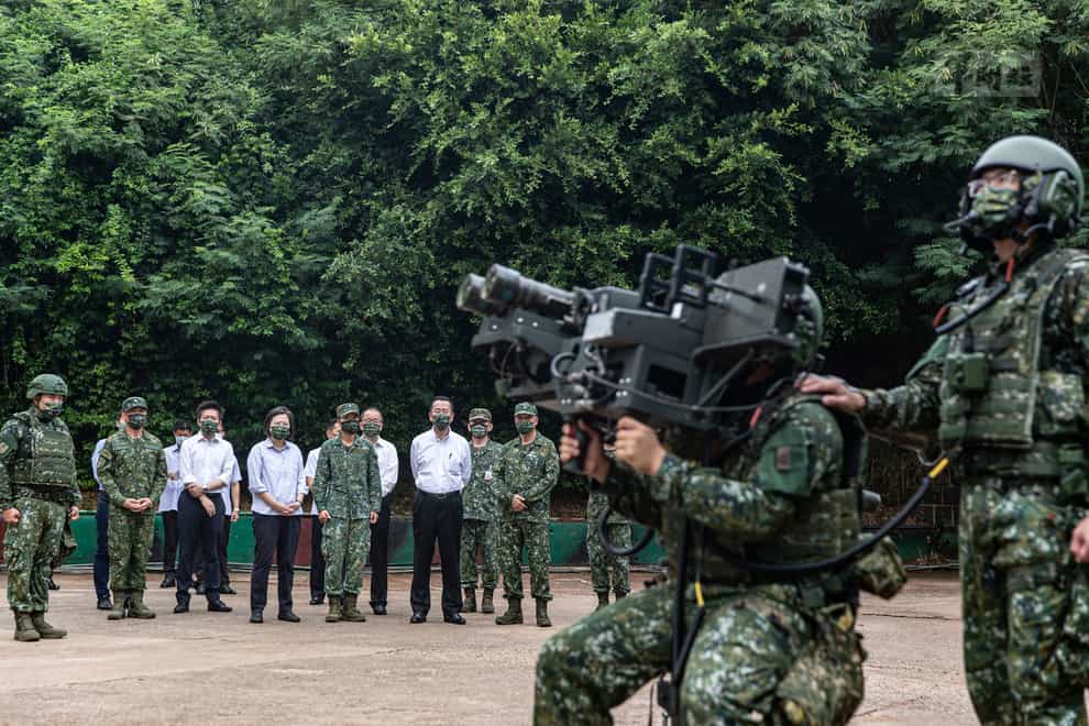 Taiwan’s president Tsai Ing-wen watches soldiers operate equipment during a visit to a naval station (Taiwan Ministry of National Defense via AP)