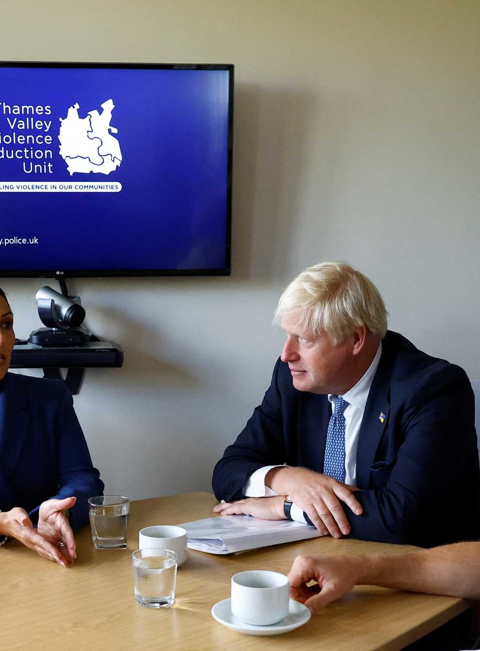 Prime Minister Boris Johnson (centre) and Home Secretary Priti Patel sit with Superintendent Marc Tarbit during a visit to Thames Valley Police (PA)
