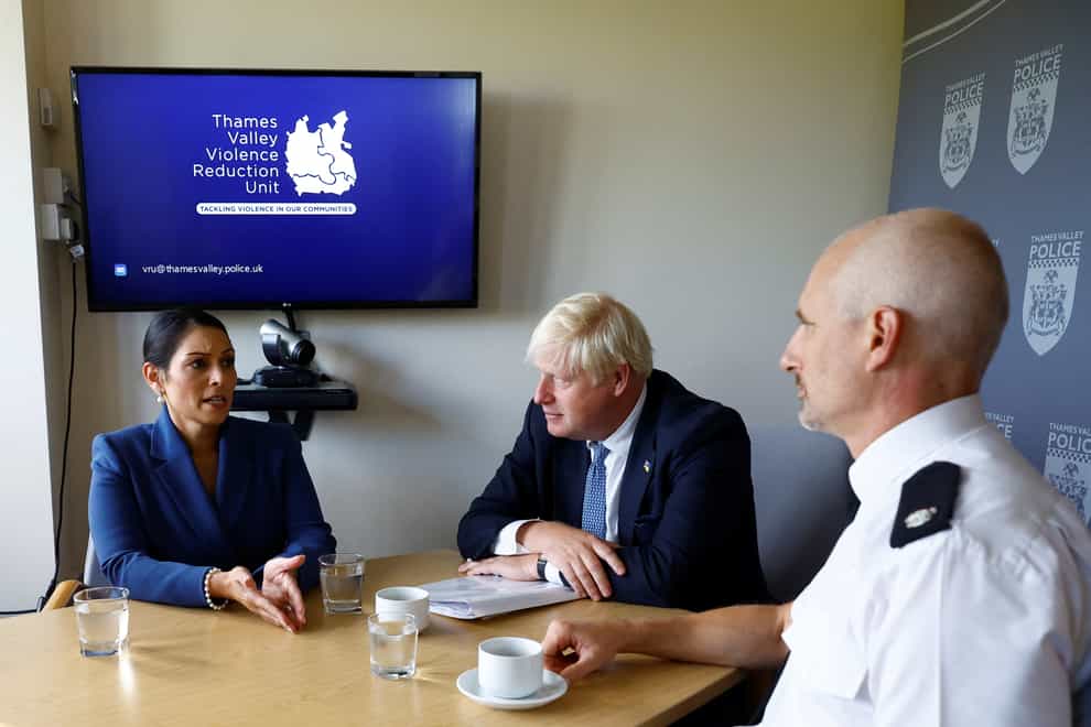 Prime Minister Boris Johnson (centre) and Home Secretary Priti Patel sit with Superintendent Marc Tarbit during a visit to Thames Valley Police (PA)