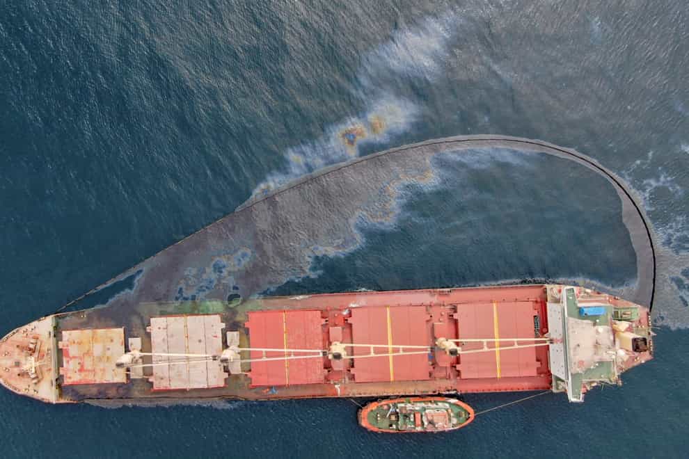 A leak of heavy fuel oil sits on the surface of the sea by the Tuvalu-registered OS 35 cargo ship that collided with a liquid natural gas carrier in the Bay of Gibraltar (HM Government of Gibraltar via AP)
