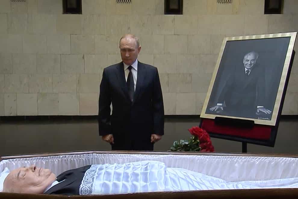 Russian President Vladimir Putin pays his last respects near the coffin of former Soviet president Mikhail Gorbachev at the Central Clinical Hospital in Moscow Russia (Russian pool via AP)