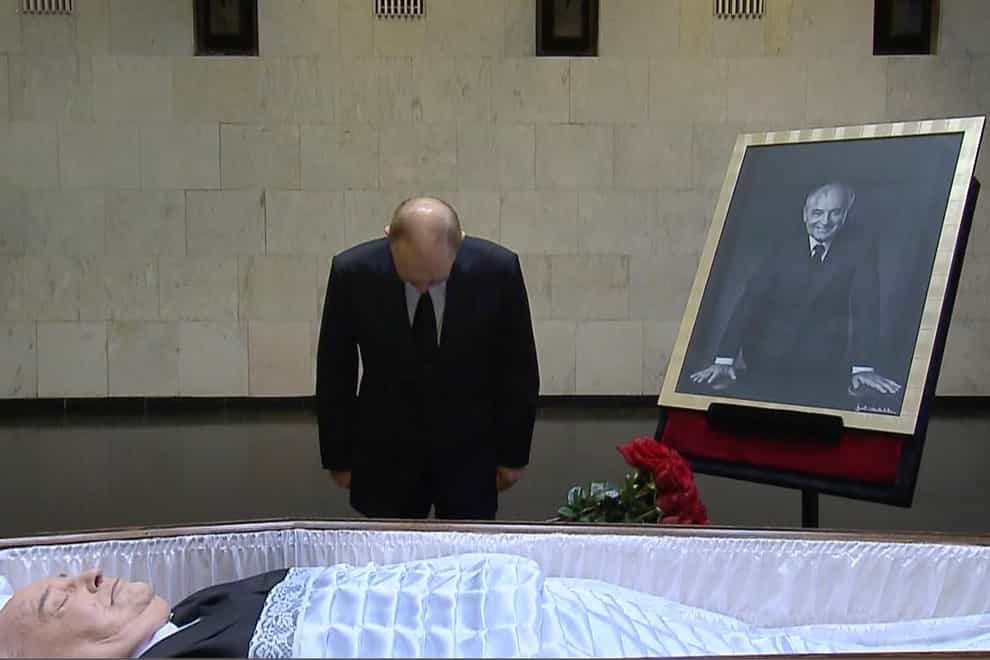 Russian President Vladimir Putin pays his last respect near the coffin of former Soviet president Mikhail Gorbachev at the Central Clinical Hospital in Moscow Russia (Russian pool/AP)