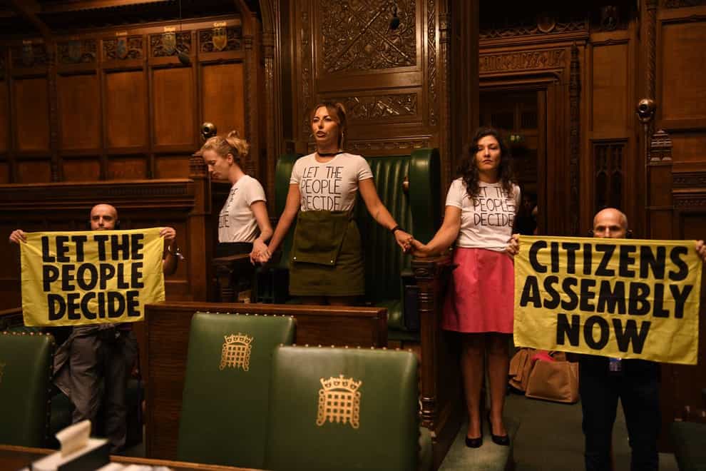 Handout photo taken with permission from the twitter feed of Extinction Rebellion of protesters who have superglued themselves around the Speaker’s chair in the House of Commons chamber, as they call for a Citizen’s Assembly. Picture date: Friday September 2, 2022 (Extinction Rebellion/PA)