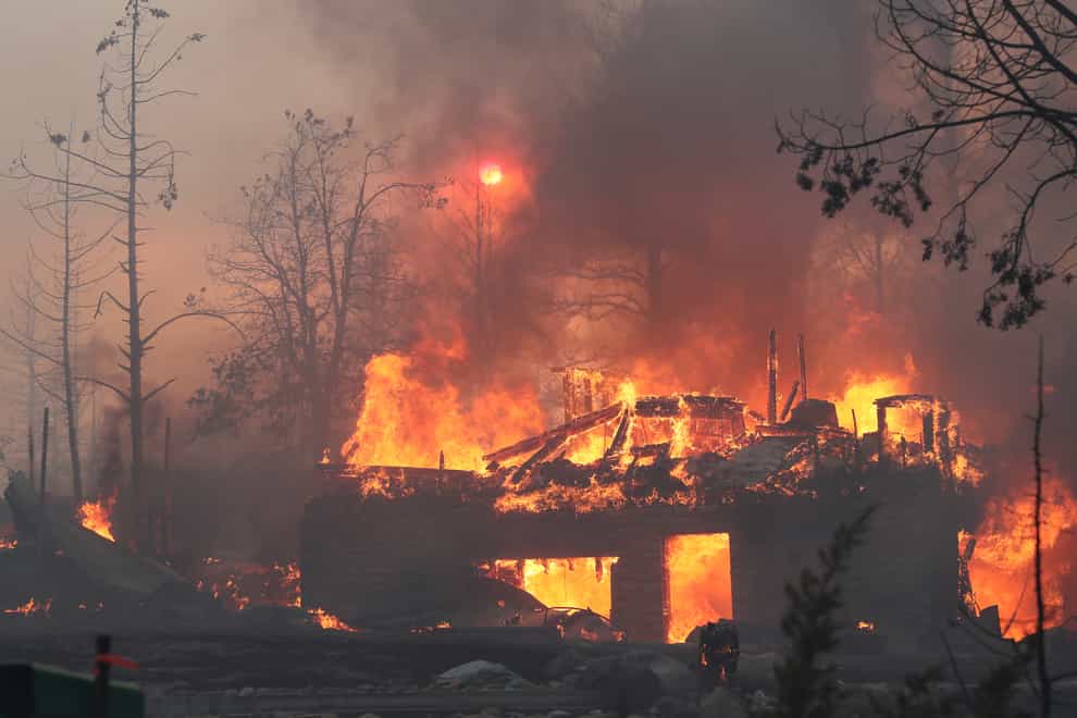 A residence goes up in flames as the Mill Fire spreads (Special to The Record Searchlight via AP)