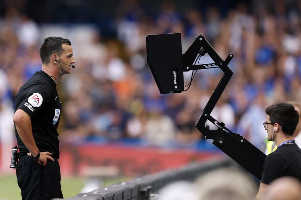 Referee Andrew Madley consults the pitchside monitor at Stamford Bridge (Steven Paston/PA)