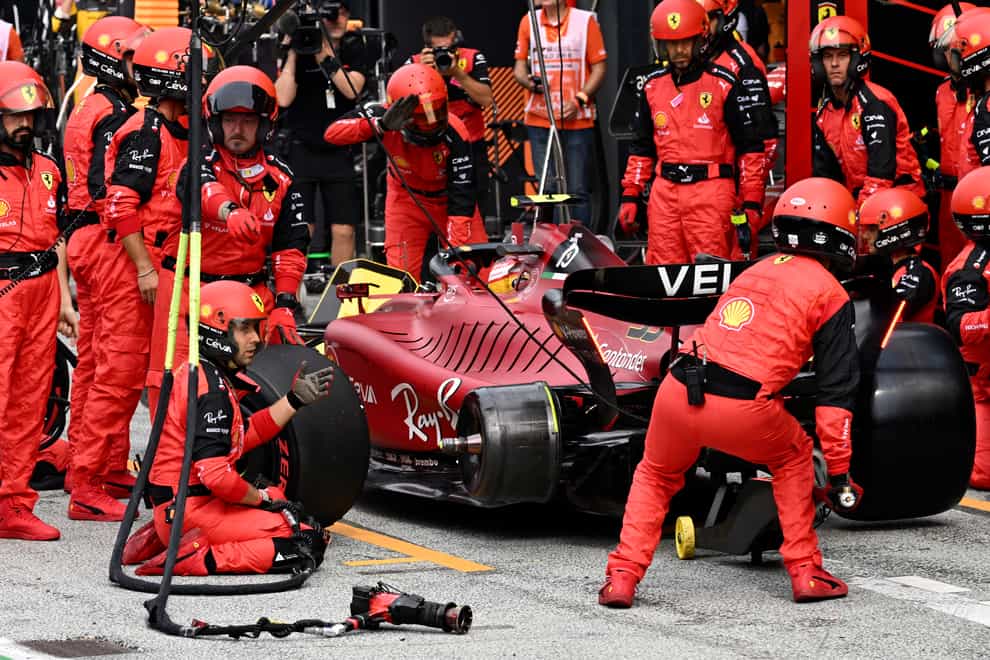 Ferrari mechanics wait for a tyre during Carlos Sainz’s stop (Christian Bruna/AP)