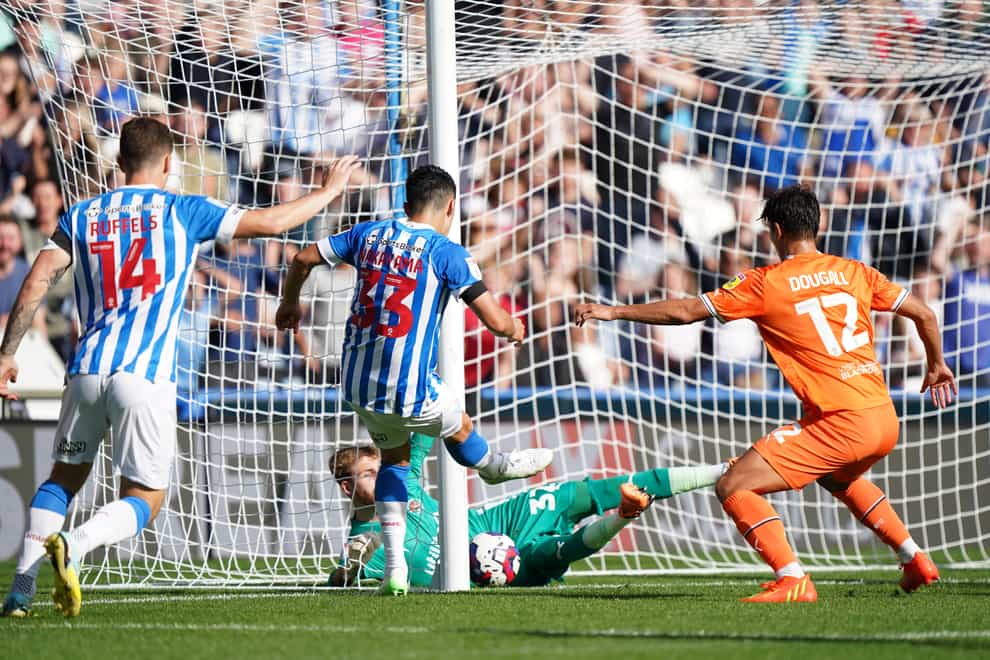 An effort by Yuta Nakayama, second left, crosses the line but is not given after the goal line technology fails to send a signal to the referee (Tim Goode/PA)