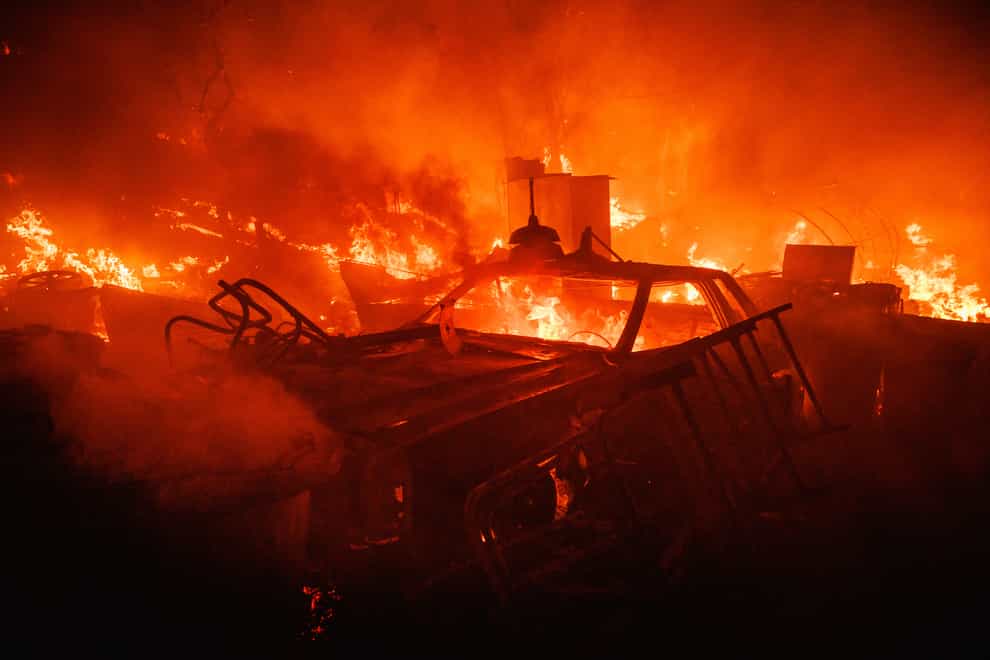 A vehicle burns near Hemet, California (Ethan Swope/AP)