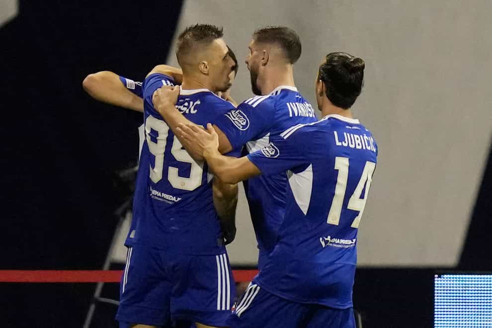 Mislav Orsic, left, celebrates with his team-mates after scoring Dinamo’s winner (Darko Bandic/AP)