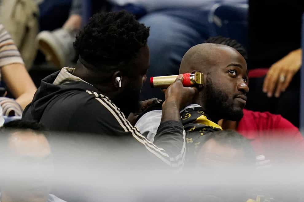 A fan gets a haircut during the match (Charles Krupa/AP)