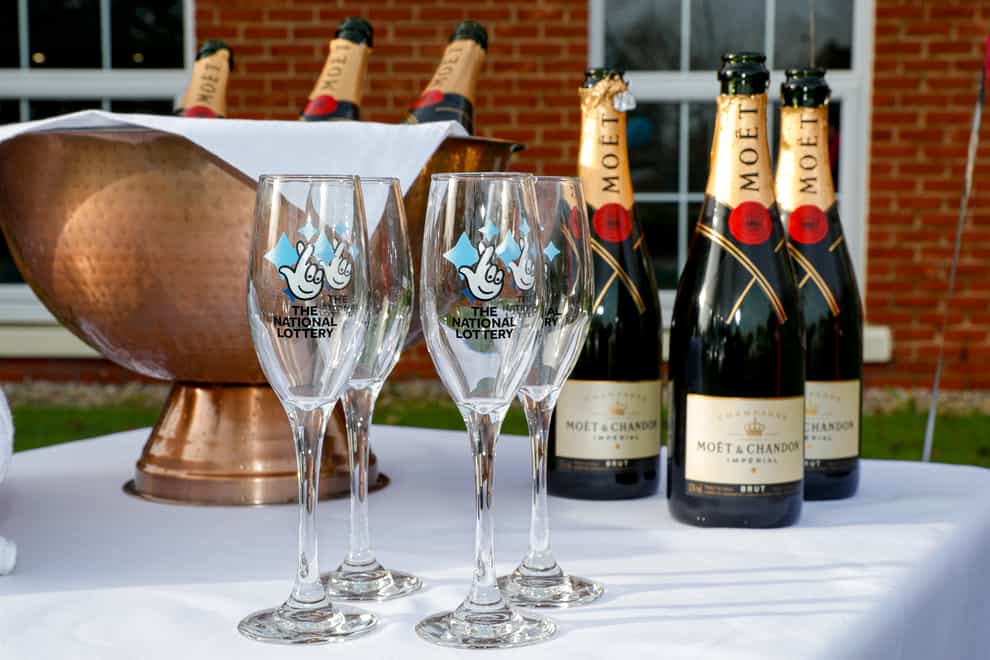 Bottles of Moet & Chandon champagne with The National Lottery branded champagne flute (Pete Byrne/PA)
