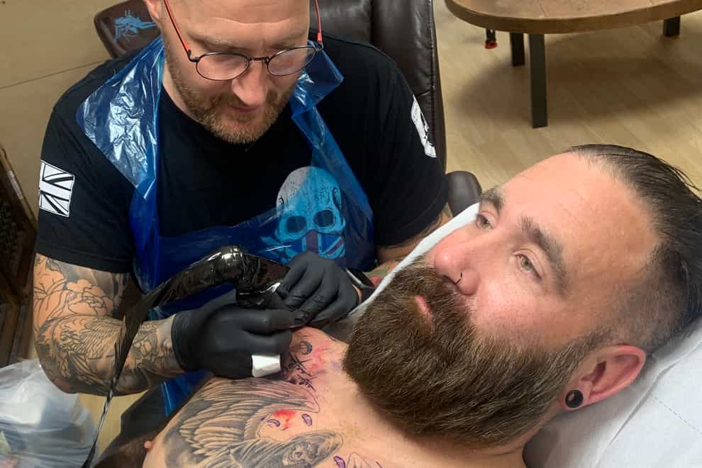 Tattoo artist Aaron Baillie working on veteran Scottie Lovegrove (Help for Heroes/PA)