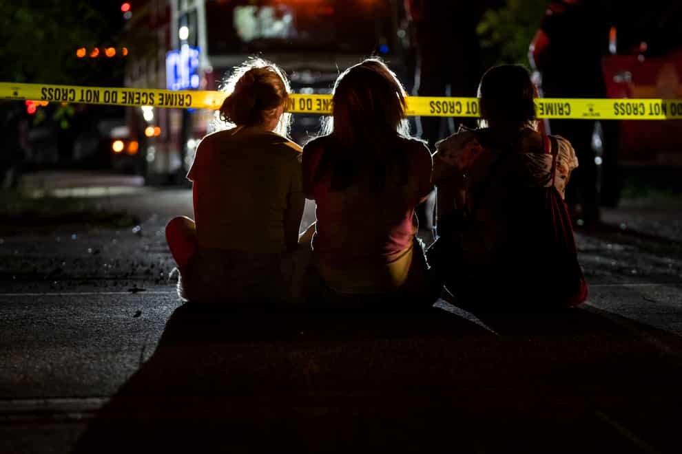 Family and friends watch as investigators search for a father and three children (Grace Hollars/The Indianapolis Star/AP)