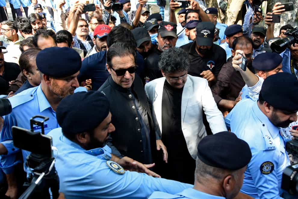 Former Pakistani prime minister Imran Khan, centre, arrives at Islamabad High Court (WK Yousafzai/AP)