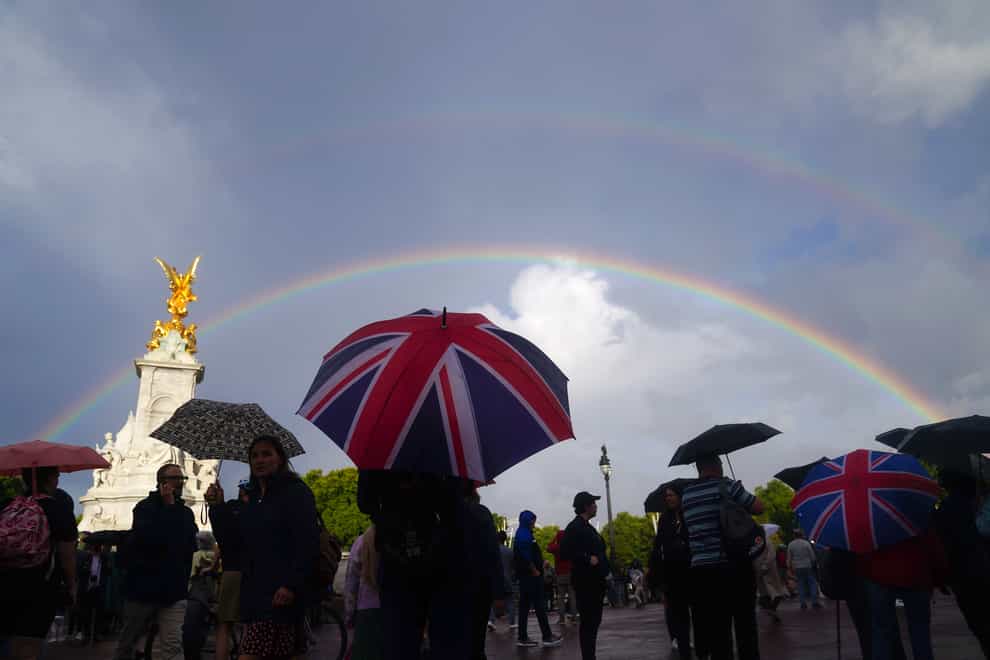 A rainbow is seen, as members of the public gather outside Buckingham Palace in central London. Queen Elizabeth II is under medical supervision with the royal family rushing to be by her side amid serious health fears. Buckingham Palace has issued a statement saying royal doctors were concerned for the Queen’s health, as the Prince of Wales and her other children, and the Duke of Cambridge cleared their diaries and immediately headed to her home in the Scottish Highlands (Victoria Jones/PA)
