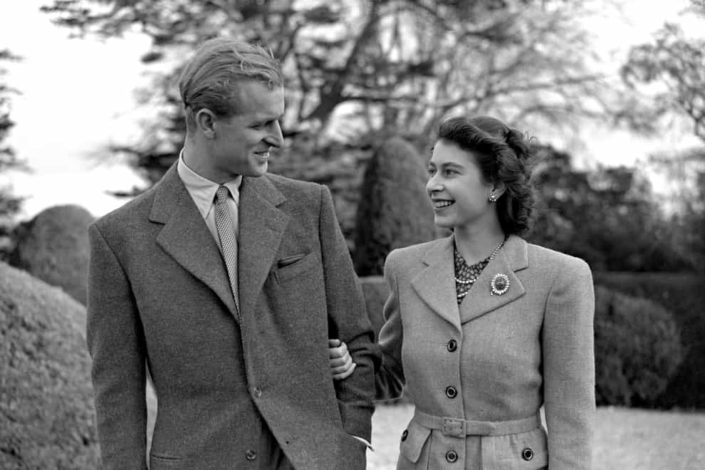 Princess Elizabeth enjoys a stroll with new husband the Duke of Edinburgh in their first public appearance since their wedding (PA)