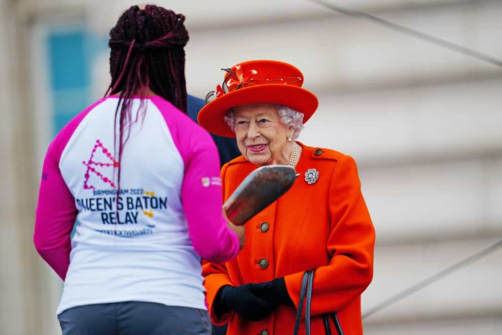 Queen Elizabeth II launched the 2022 Birmingham Commonwealth Games baton relay at Buckingham Palace, handing it to Kadeena Cox (left) (Victoria Jones/PA)