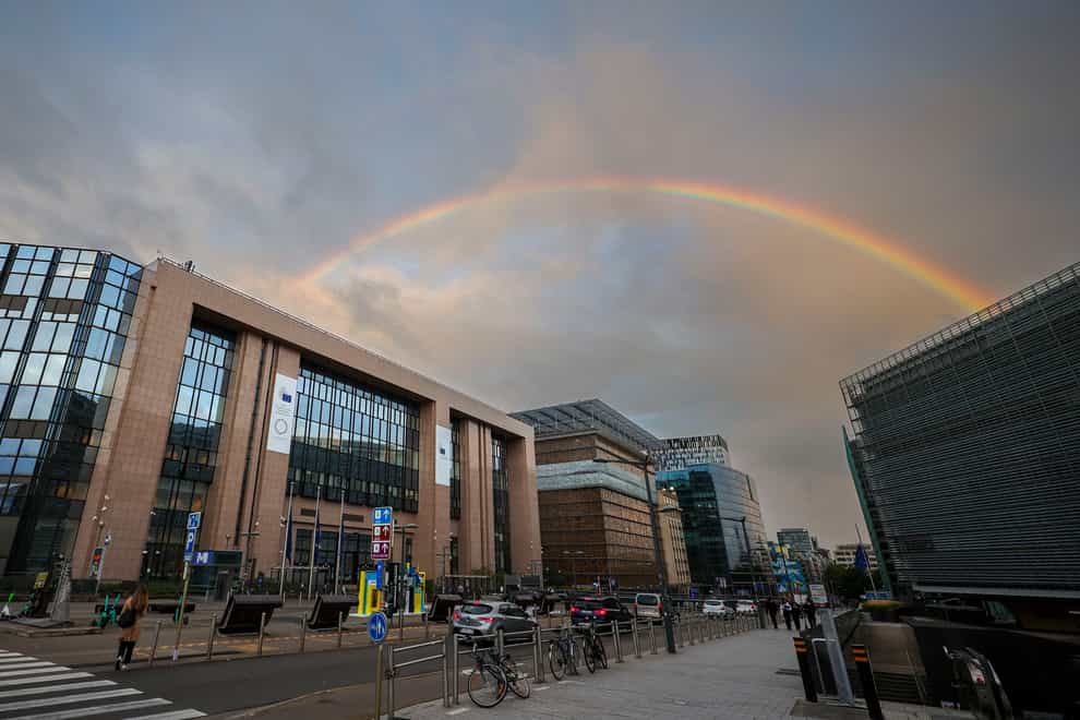 A rainbow forms between the European Council building and the European Commission building (AP)