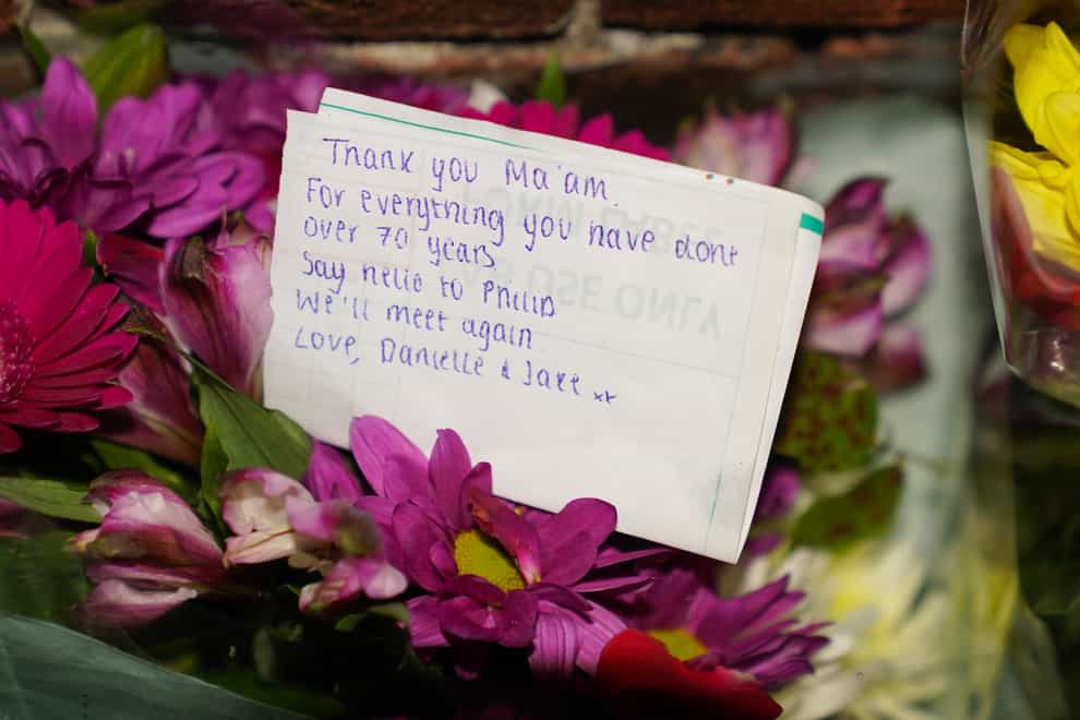 Floral tributes and messages left at the gates of Sandringham House (Joe Giddens/PA)