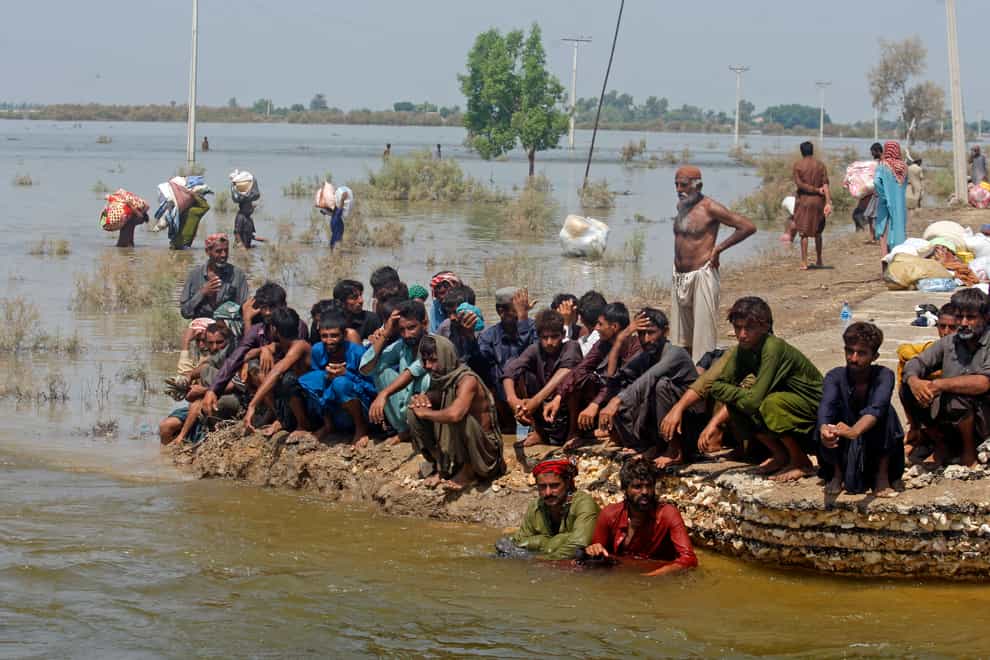 Victims of heavy flooding from monsoon rains wait to receive relief aid from the Pakistani army in the Qambar Shahdadkot district of Sindh Province, Pakistan (Fareed Khan/AP)