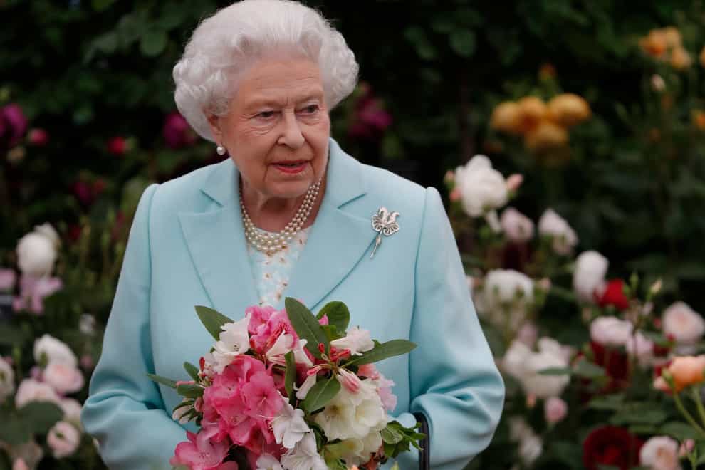 The Queen was tending roses when she spoke to American tourists (Adrian Dennis/PA)