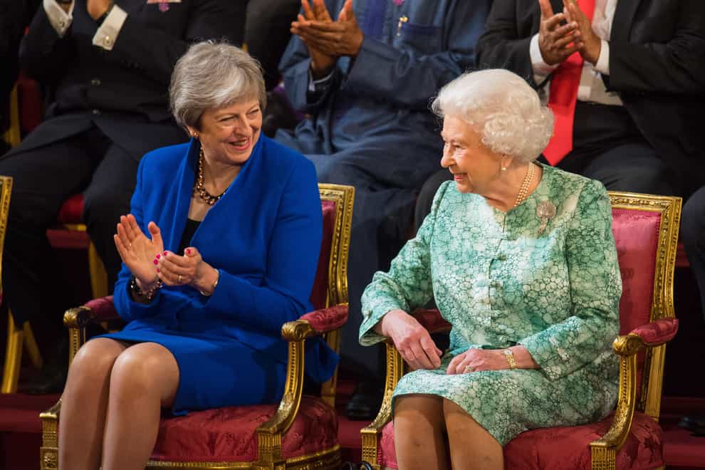 Theresa May and the Queen in 2018. ‘She joined in our celebrations with joy and a mischievous smile,’ said Mr May in her Commons tribute (Dominic Lipinski/PA)
