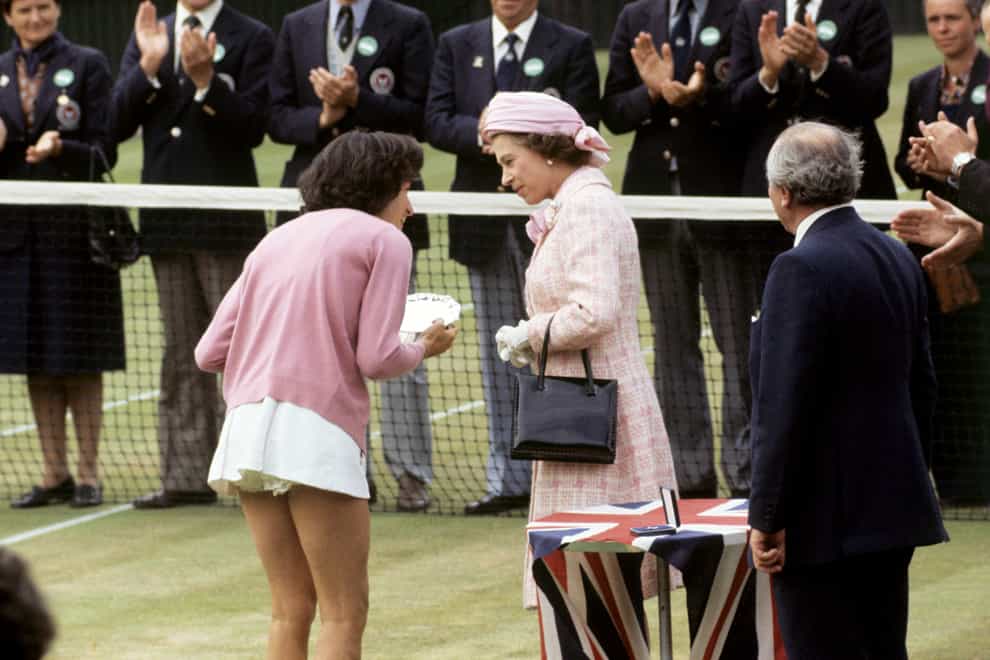 Virginia Wade receives the Wimbledon trophy from the Queen (PA)