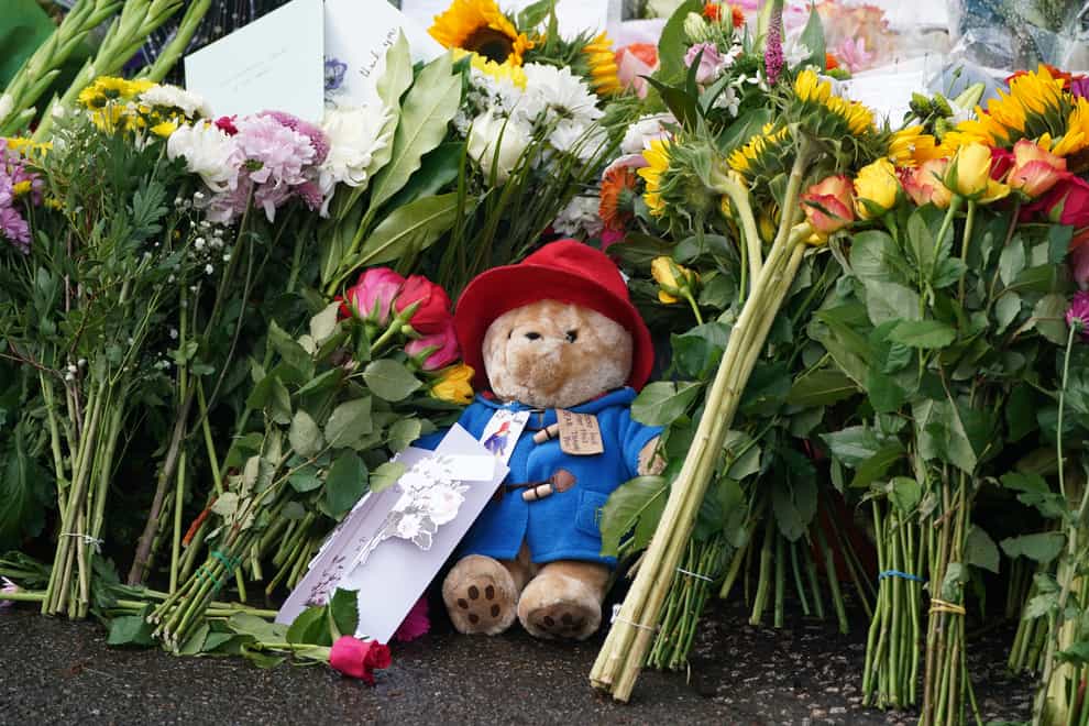 Floral tributes and a Paddington Bear teddy are laid at the gates of Balmoral Castle (Andrew Milligan/PA)