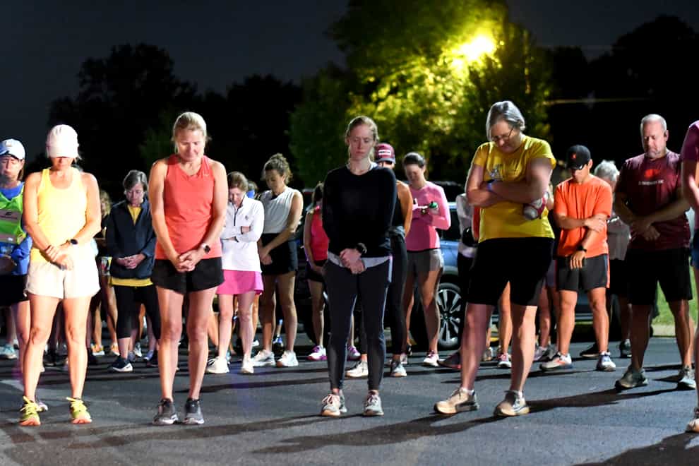 Runners share a moment of silence before the start of Finish Eliza’s Run in Chattanooga, Tennessee (Robin Rudd/Chattanooga Times Free Press via AP)