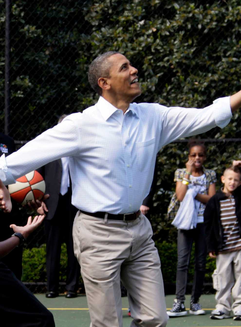 Barack Obama, front right, plays basketball with former NBA basketball player Bruce Bowen, front left, during the annual White House Easter Egg Roll at the White House in Washington in 2012 (Carolyn Kaster/AP)