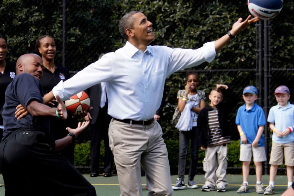 Barack Obama, front right, plays basketball with former NBA basketball player Bruce Bowen, front left, during the annual White House Easter Egg Roll at the White House in Washington in 2012 (Carolyn Kaster/AP)