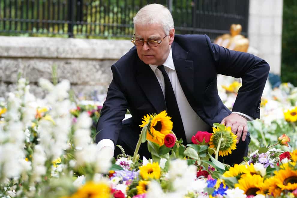 The Duke of York views the messages and floral tributes left by members of the public at Balmoral (PA)