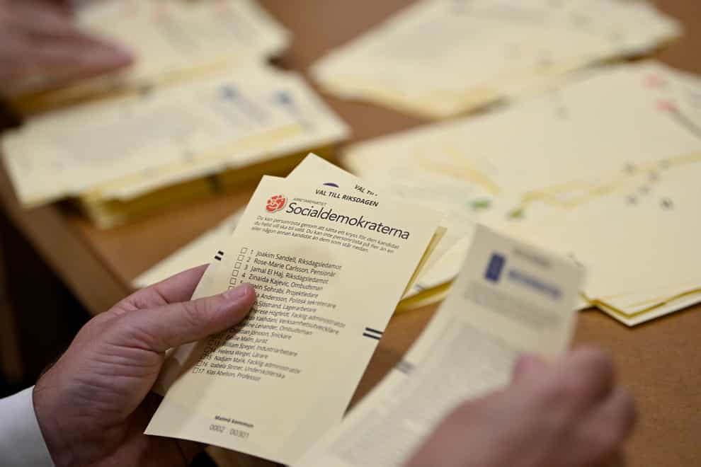 Poll workers count votes at a polling station at Hasthagens Sport Center in Malmo, Sweden (Johan Nilsson/TT News Agency/AP)