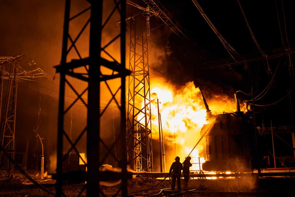 Ukrainian firefighters battle flames after a Russian rocket attack hit an electric power station in Kharkiv (Kostiantyn Liberov/AP)