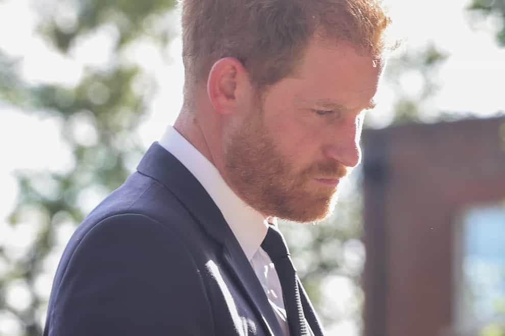 The Duke of Sussex viewing the messages and floral tributes left by members of the public at Windsor Castle in Berkshire following the death of Queen Elizabeth II (PA)